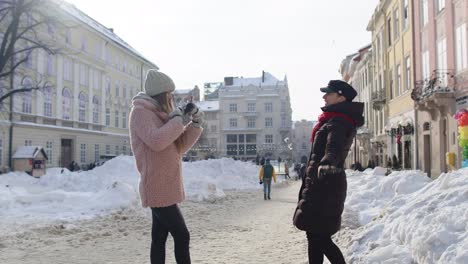 Sisters-couple-bloggers-taking-photo-pictures,-posing,-making-online-video-vlog-on-mobile-phone