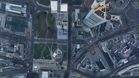 Aerial-birds-eye-overhead-top-down-panning-view-of-downtown-skyscrapers-in-financial-and-economic-borough.-Sparse-clouds-limiting-visibility.-Frankfurt-am-Main,-Germany