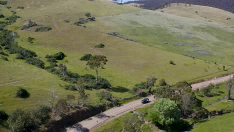 A-car-driving-through-the-breathtaking-beauty-of-the-Australian-wilderness,-where-adventure-and-stunning-landscapes-await