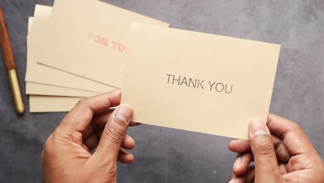 thank you message and envelope on wooden table