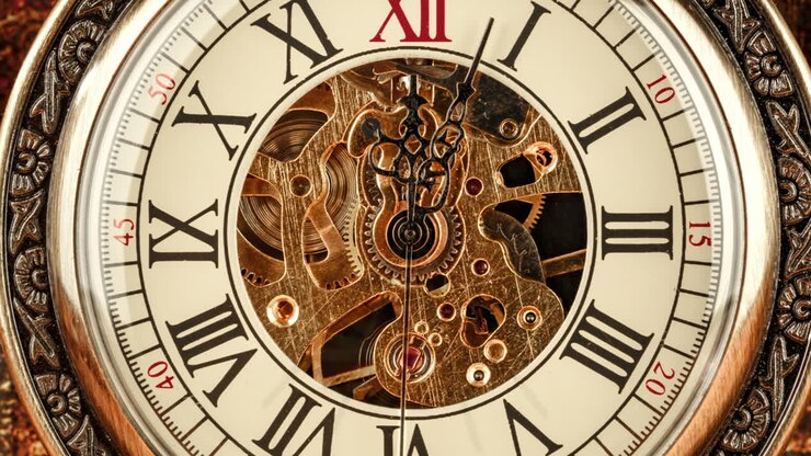 Vintage antique pocket watch against the background of old books