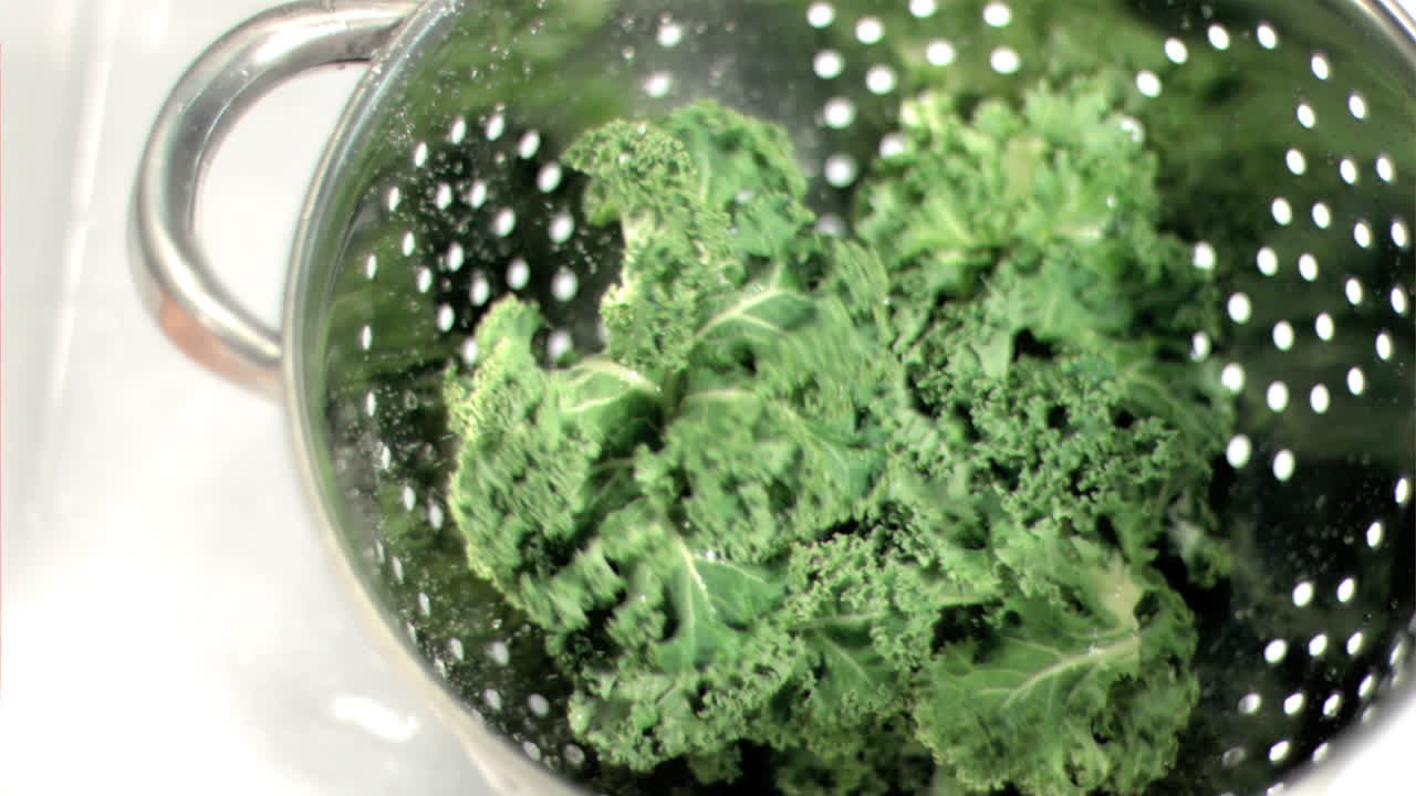Kale falling into sieve in super slow motion