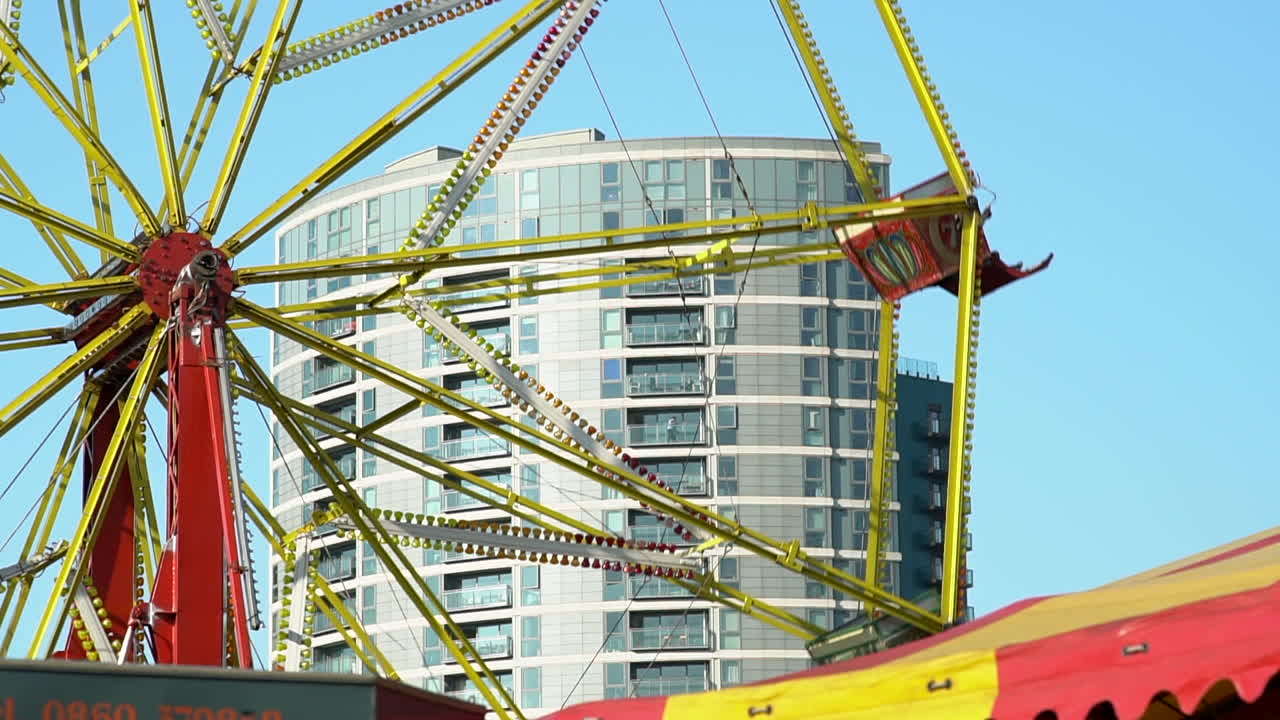 Ferris Wheel Amusement Ride buckets spinning at the Fun Fair