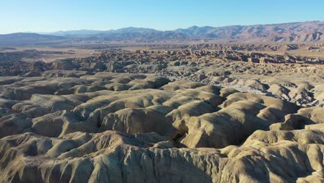 aerial flyover arroyo tapiado mud cave landscape during sunny day and blue sky in california