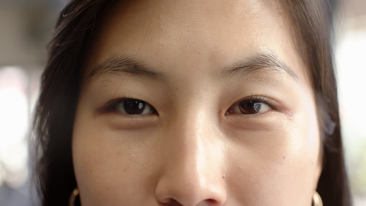 Close-up of woman's eyes expressing calm and confidence in natural light, at office
