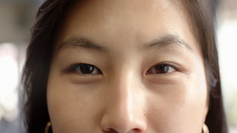 close-up of woman's eyes expressing calm and confidence in natural light, at office
