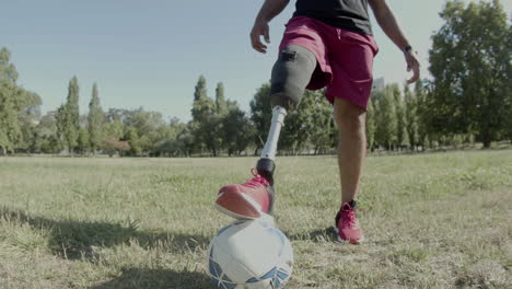 vertical motion of man with disability putting his leg on ball