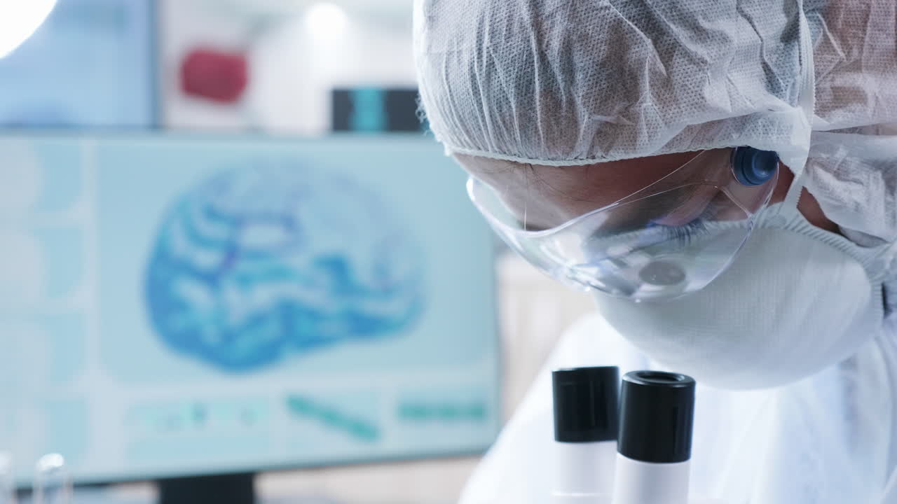 Scientist working in a lab with a microscope