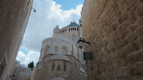 Dormition Abbey in Jerusalem, Israel, seen from a narrow street. Slow motion.