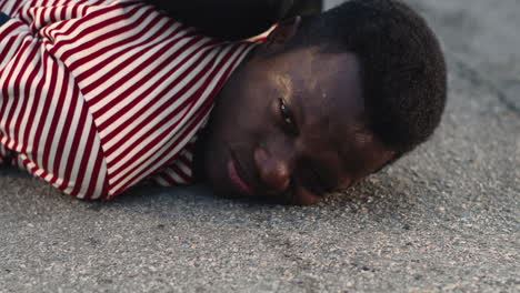 man lying on asphalt