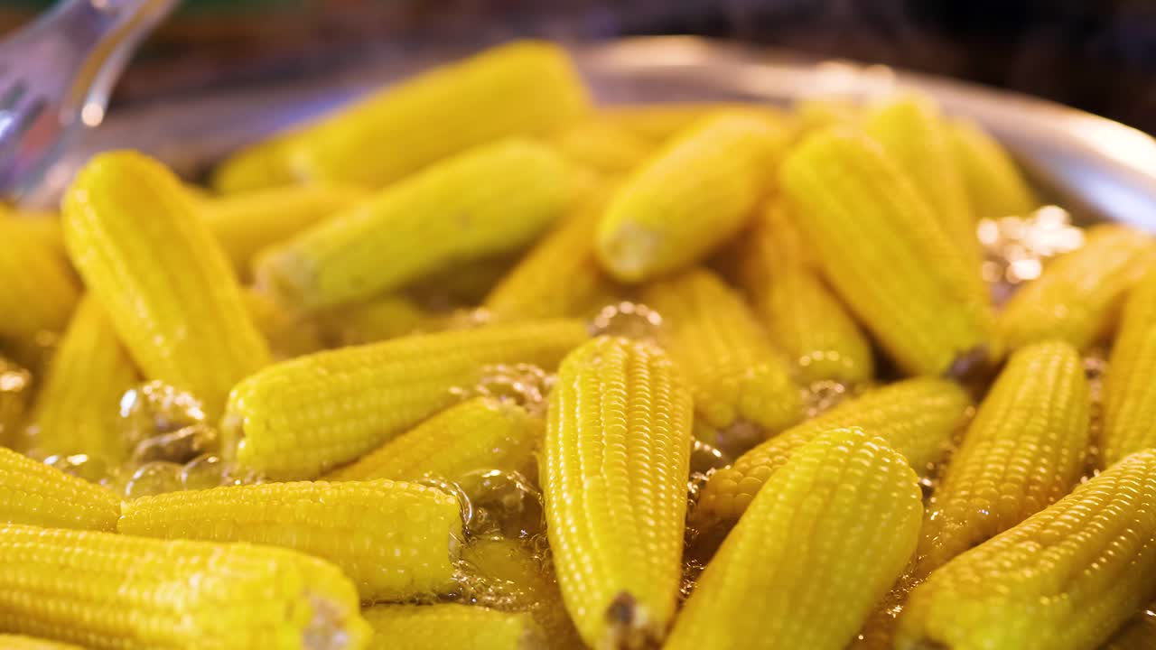 Sweet corn boiling in a large pot