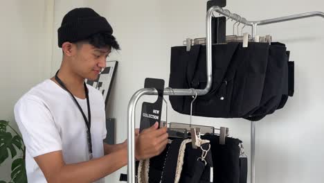 shop workers tidy up bags for sale