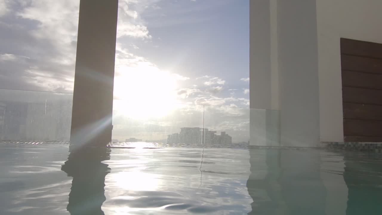 wide shot of a white wall in public swimming pool, sunshine in the caribbean