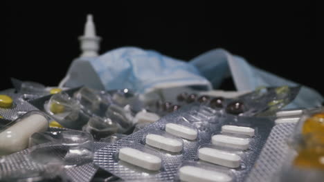 colorful pills as virus treatment on black background