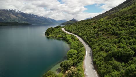 road along lake wakatipu from queenstown to glenorchy with stunning mountain views in new zealand