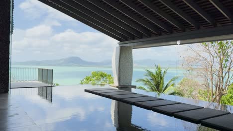 a tranquil infinity pool with a stunning view of phang nga bay, capturing the serene beauty of phuket, thailand