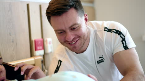 happy father touching big belly of his expecting wife. woman speaks on the phone and makes a wry face from contractions.
