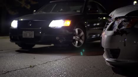 nighttime encounter: two cars face off in a darkened parking lot, capturing an electric atmosphere of uncertainty and intensity