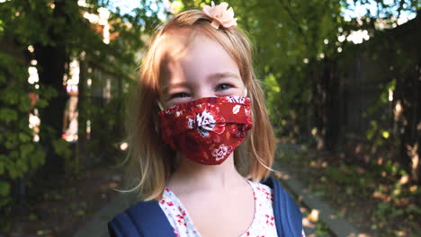 adorable little girl and her doll both wearing face masks