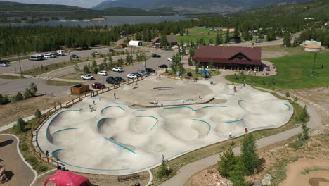 rising aerial view of the frisco skateboard park with the dillon reservoir off in the distance in colorado