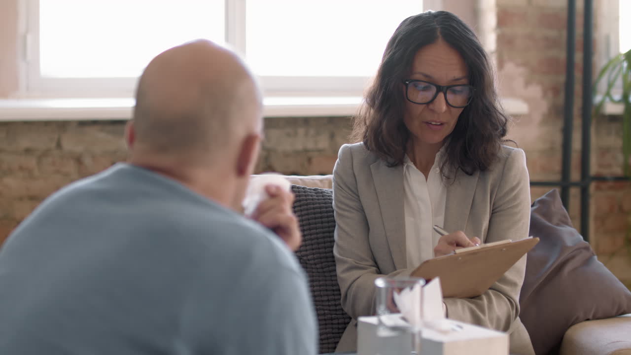Psychotherapist Talking to Emotional Male Client