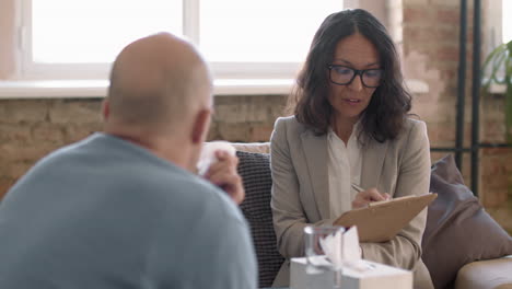 Psychotherapist Talking to Emotional Male Client