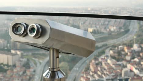 coin-operated binoculars looking out over city buildings