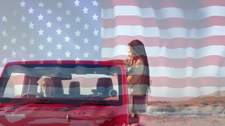 Animation of flag of usa over happy diverse women in car by beach in summer