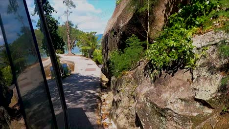 view from public bus traveling down small roads on tropical island