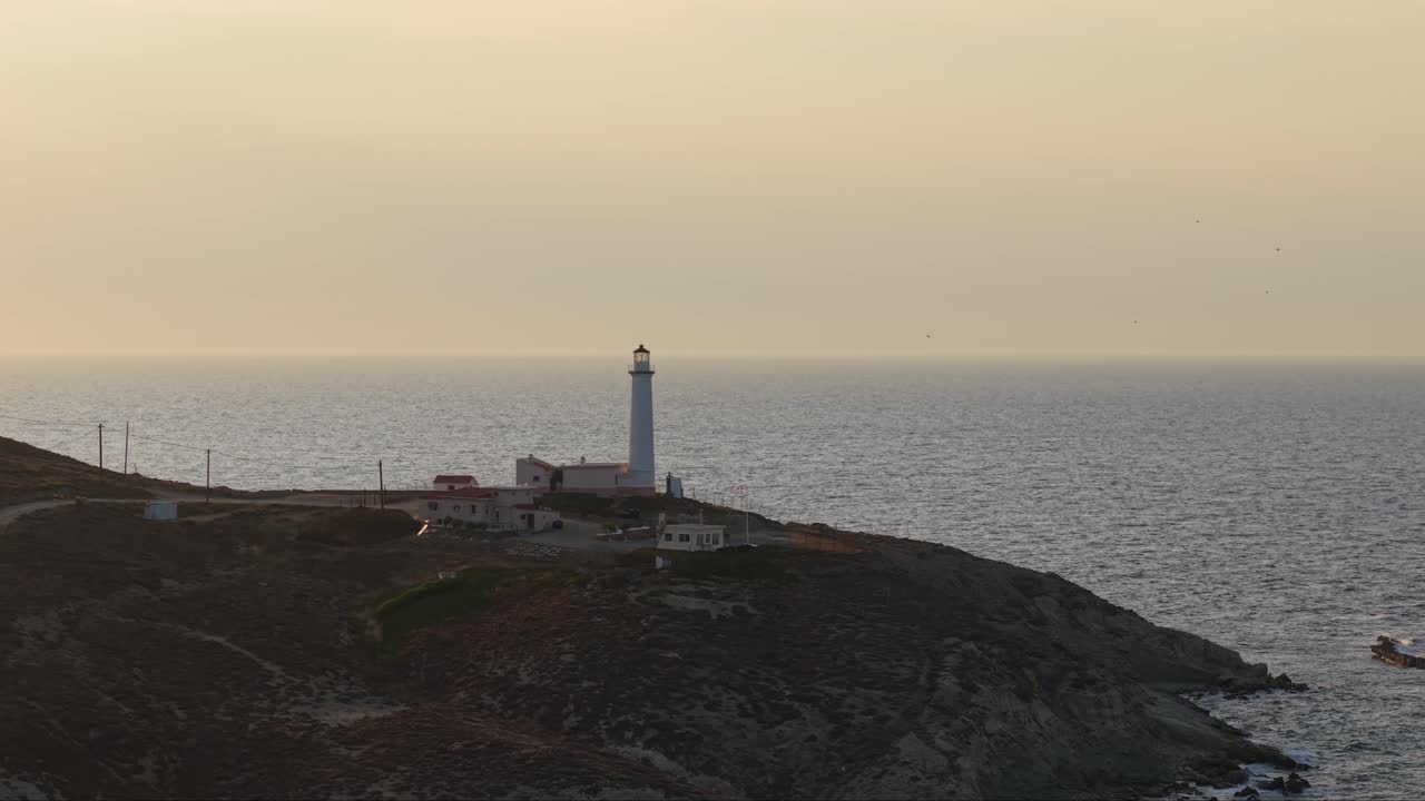 Orbiting the lighthouse of Lemnos in the afternoon, showcasing the Aegean Sea and the scenic coastal landscape in the background