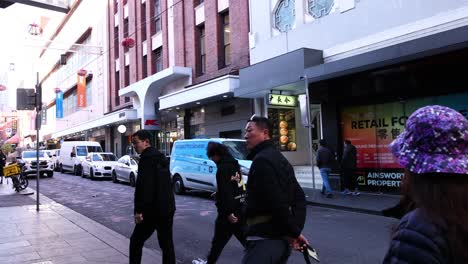 pedestrians walking in melbourne's chinatown street