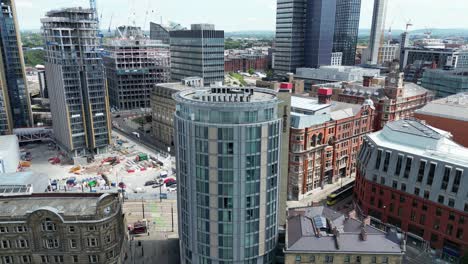 Aerial-drone-flight-around-tall-towers-in-Manchester-City-Centre-currently-under-development-with-the-Co-operative-Building-in-the-background