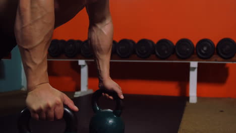 muscular man performing push-up exercise with kettlebell