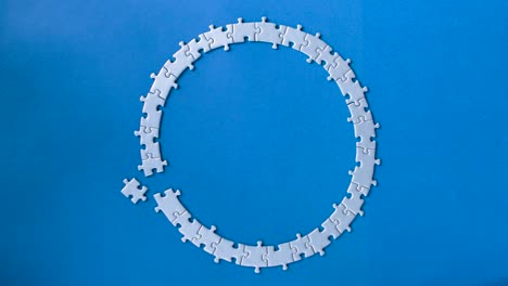 grey puzzles isolated on blue background. social issue concept