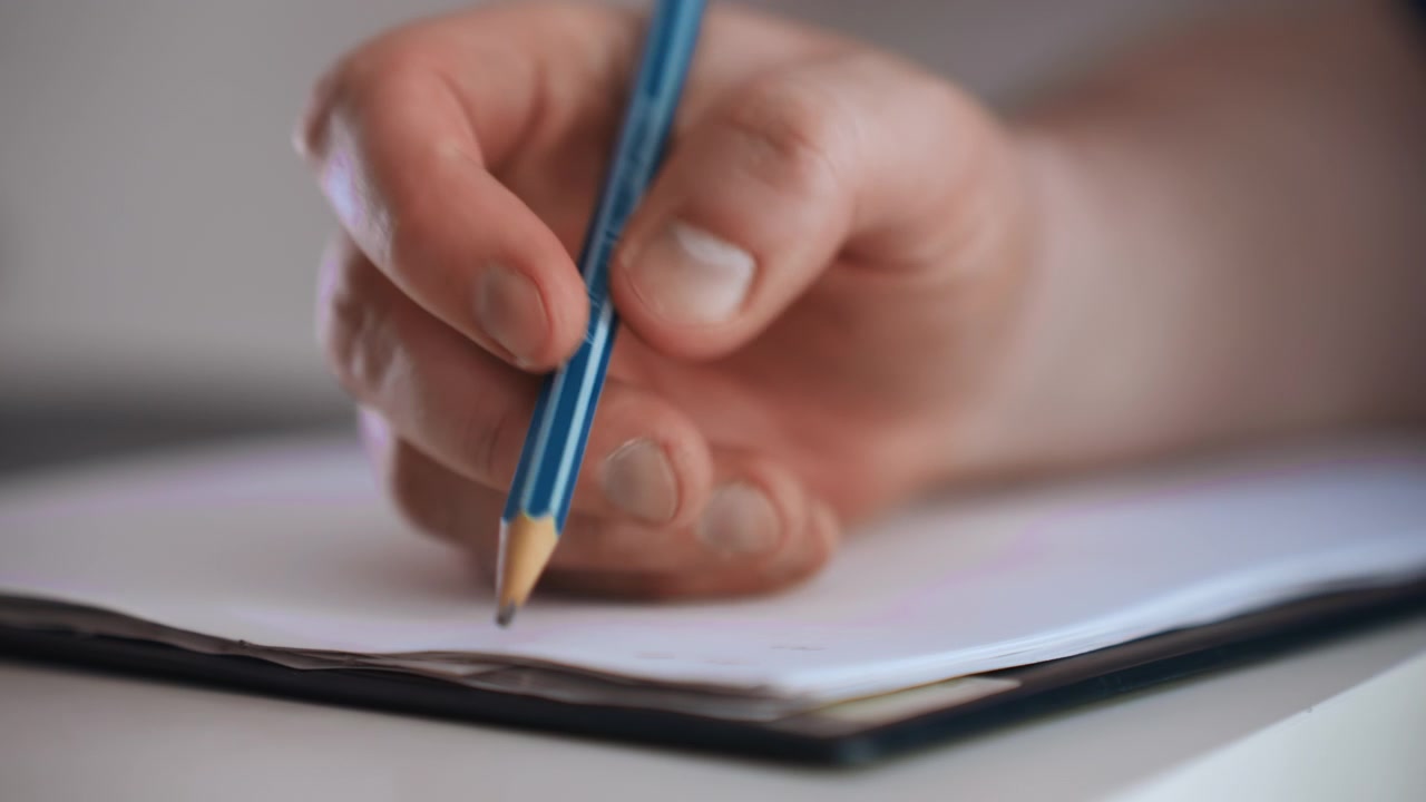 Paramedic documenting home patient notes, closeup hand holding pencil over notebook, visible fingernails and graphite tip, soft natural lighting, blurred residential background, focused checklist