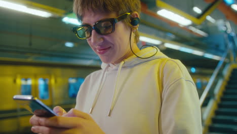 young woman messaging on mobile phone on underground station
