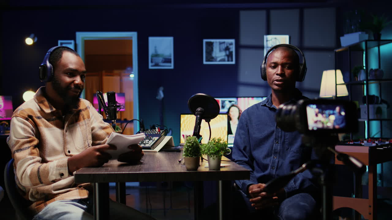 Presenter records online podcast episode with man using professional equipment