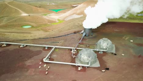 beautiful drone shot of the krafla geothermal area in iceland with pipes steaming vents and sheep warming themselves 1