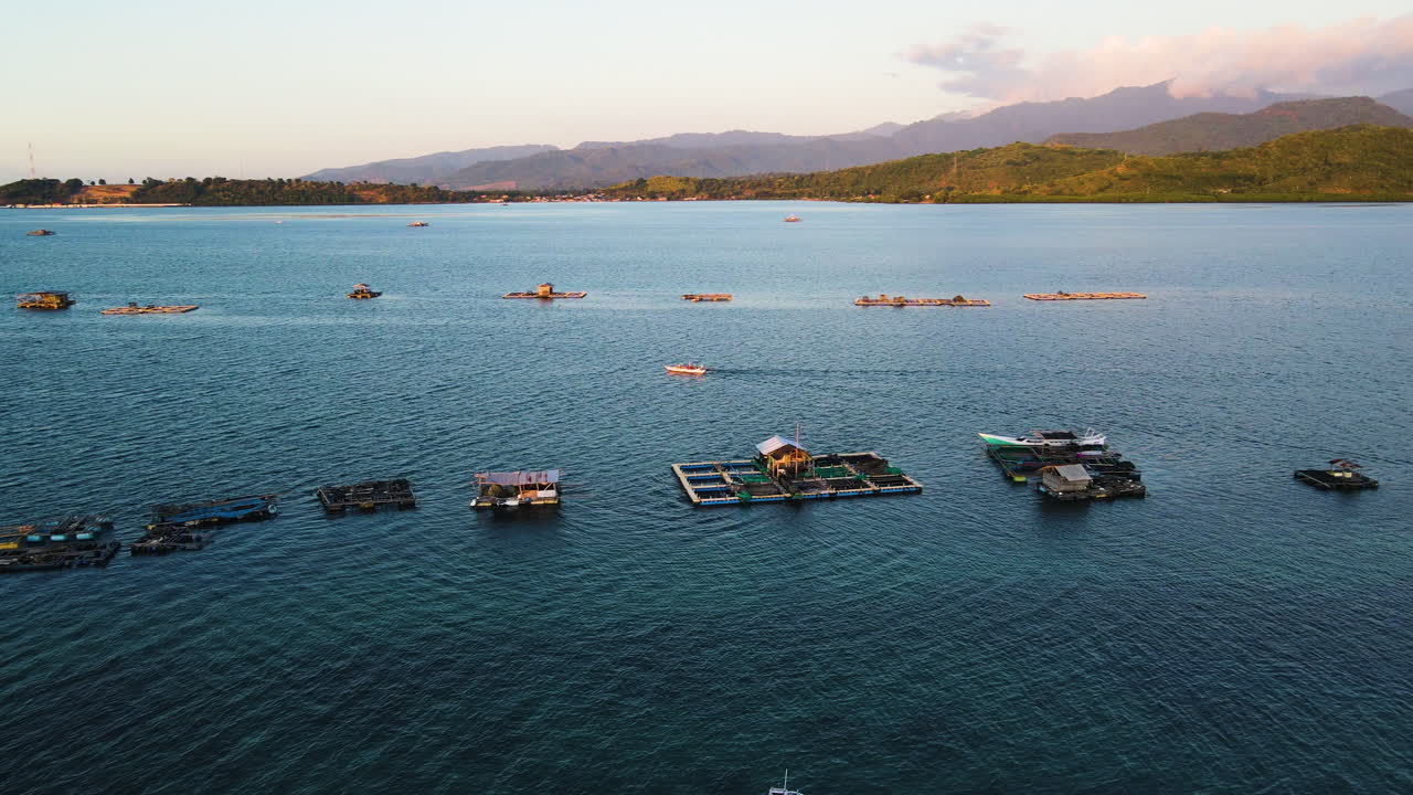 Boat And Wooden Raft Floating In The Blue Sea At Sunrise In Indonesia. - aerial shot