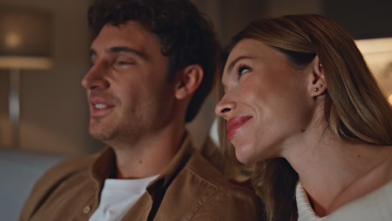 Closeup loving sweethearts relaxing together at evening apartment. Romantic date