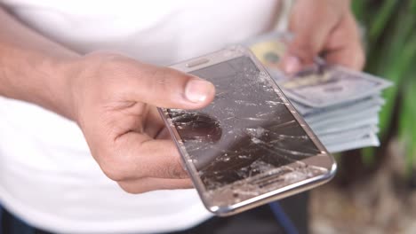 broken smartphone with money