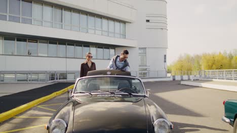 couple in vintage convertible car