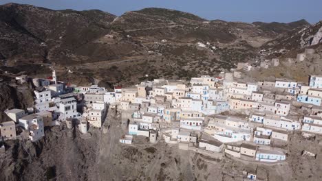 orbit 4k cinematic aerial video of olympos village, karpathos: colorful houses and mountain