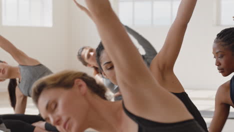 healthy yoga woman practicing seated side bend pose young mixed race female enjoying fitness lifestyle exercising in studio with group of multiracial women