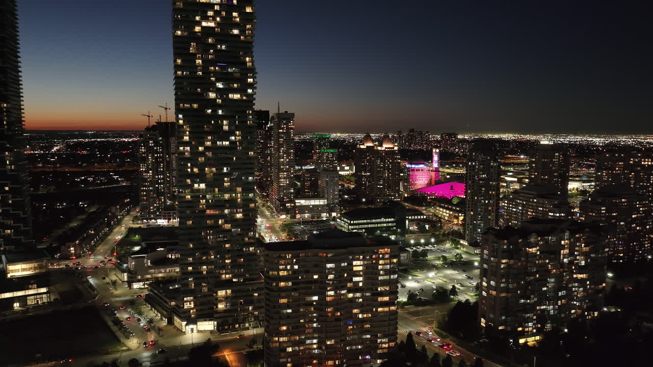 Vista aérea do centro de Mississauga com a prefeitura ao entardecer, luzes noturnas vibrantes