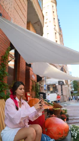 woman taking a selfie in an outdoor cafe