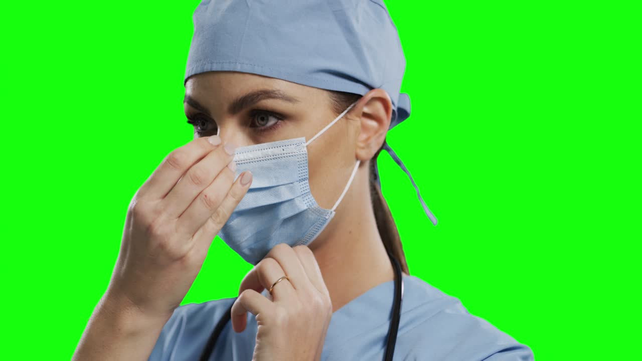 doctora caucásica con máscara facial en el fondo de la pantalla verde