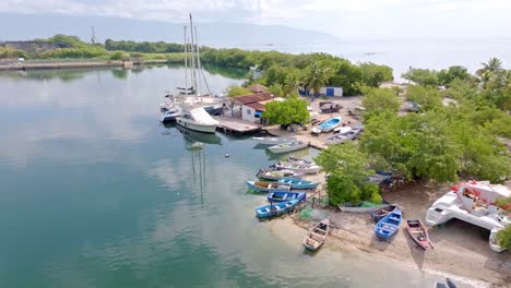 drone approaching shot of anchored boats and yachts in bay of barahona city, dominican republic