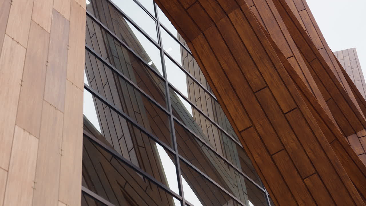 Reflection of wooden beams on glass panels of tall health club exterior, showcasing elegant architectural design and modern construction style with clean lines and vertical structure