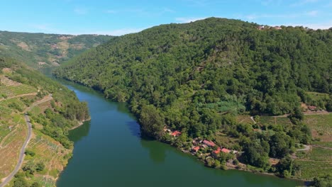 coastal village and forested mountains at belesar in lugo, galicia, spain